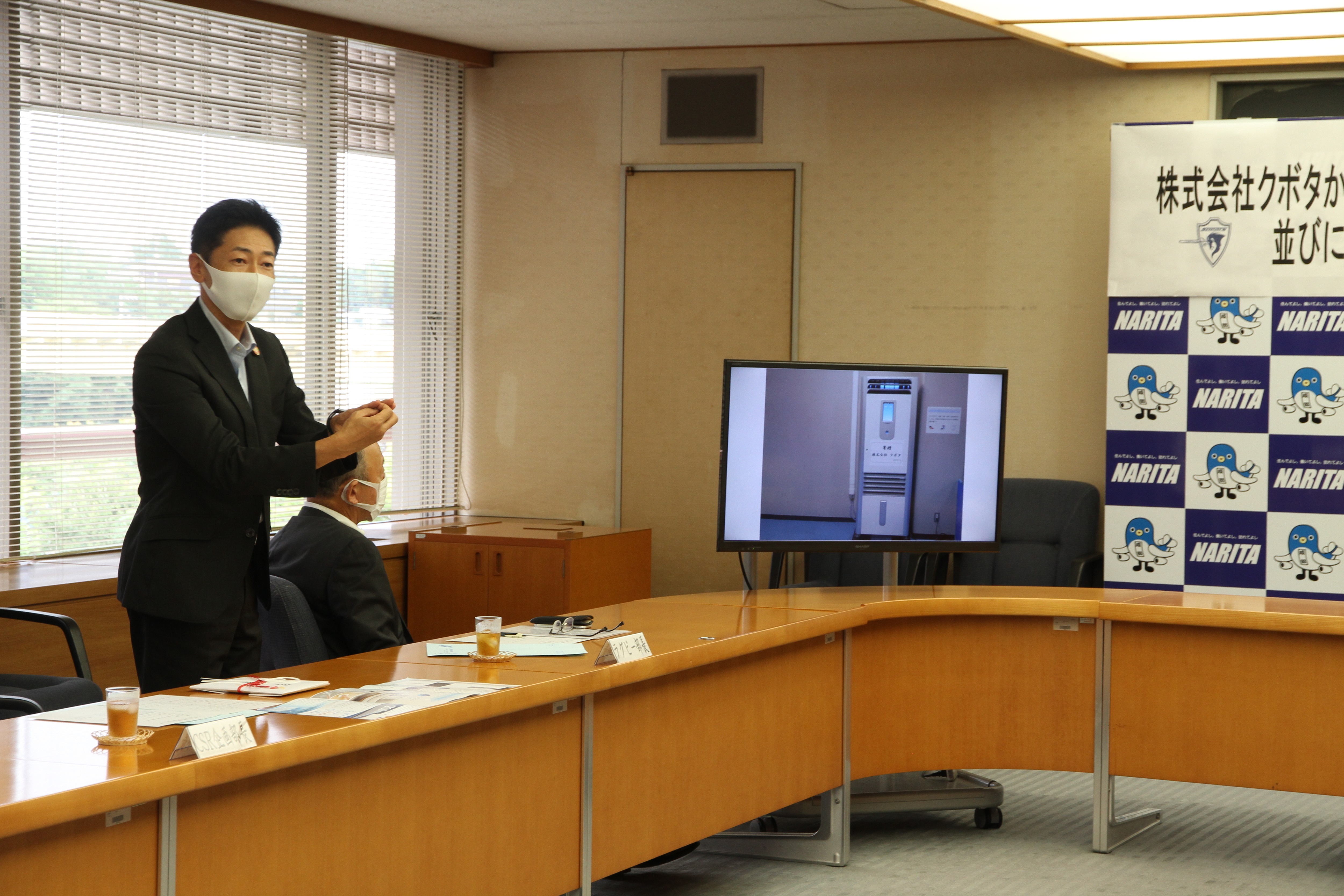 株式会社クボタ菱田CSR企画部長が加湿空気清浄機の機能を説明する様子